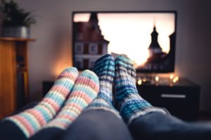 image of socks on feet in front of tv